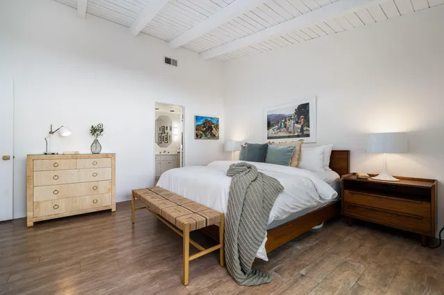 a bedroom with a bed and a dresser