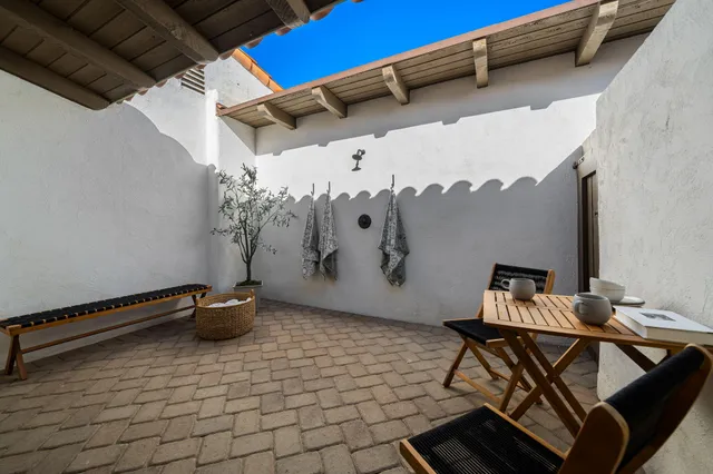 a view of a patio with a table and chairs