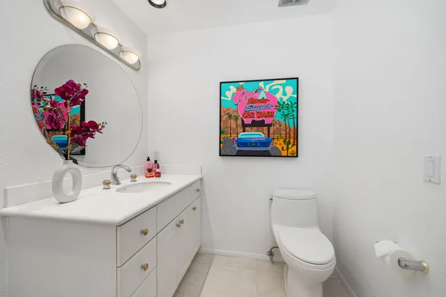 a bathroom with a sink mirror and vanity
