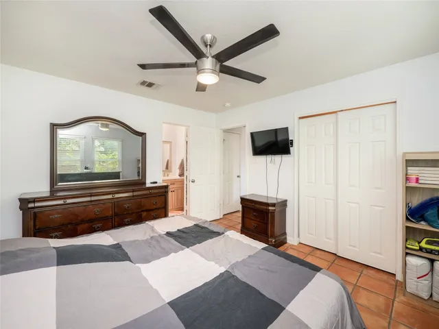 a bedroom with a bed and a television