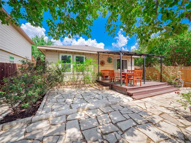 a view of a chairs and tables in the back yard of the house