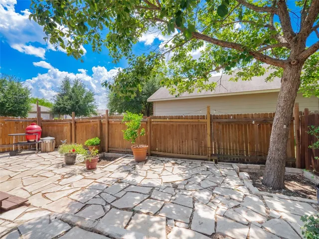 a view of a backyard with a small cabin and chair