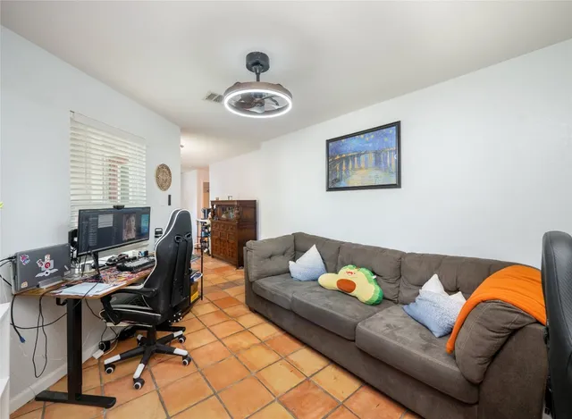 a living room with furniture a piano and a window