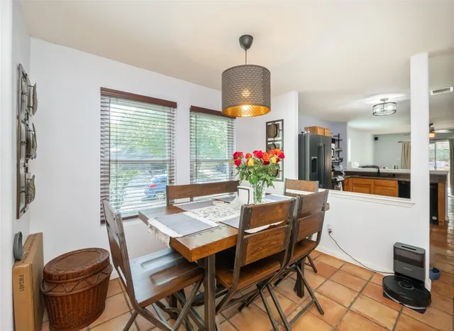 a dining room with furniture and window