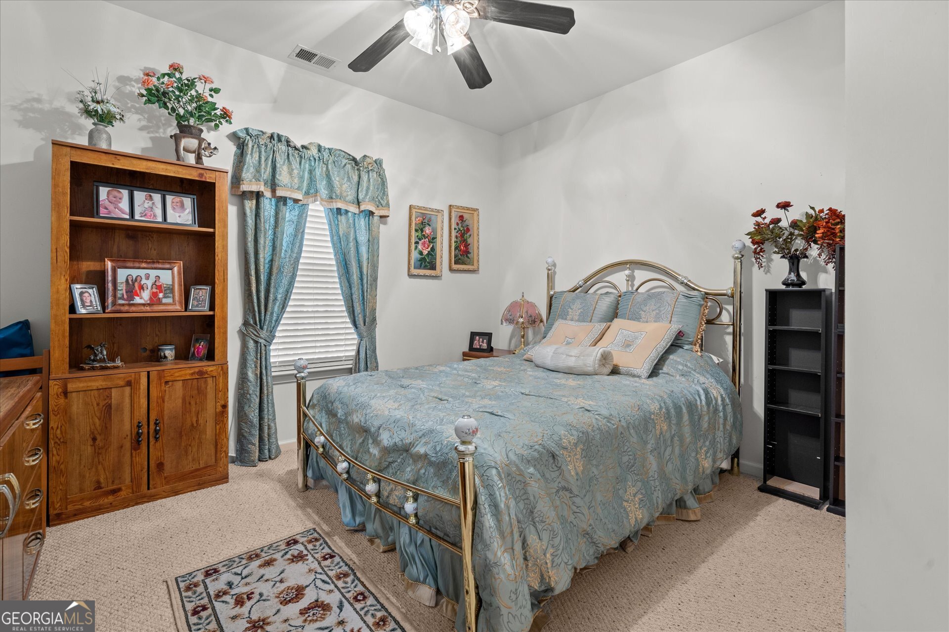 4051 Golfview Court Villa Rica, GA 30180 - Photo 31 of 77 a bedroom with a bed a dresser and book shelf