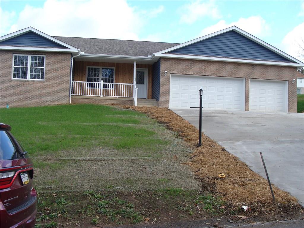 FRONT VIEW, PORCH, 3 CAR GARAGE, CONCRETE DRIVEWAY, BRICK TO GRADE CONSTRUCTION
