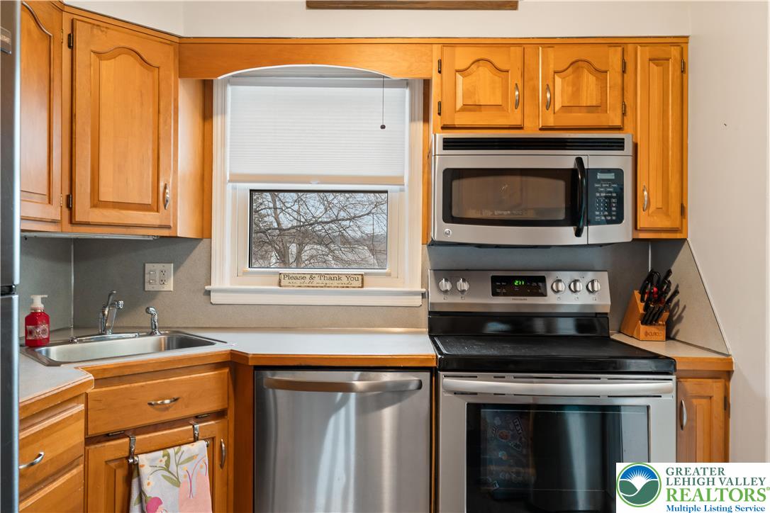 1937 Greenleaf Street Bethlehem, PA 18017 - Photo 20 of 45 a kitchen with stainless steel appliances wooden cabinets and a stove top oven