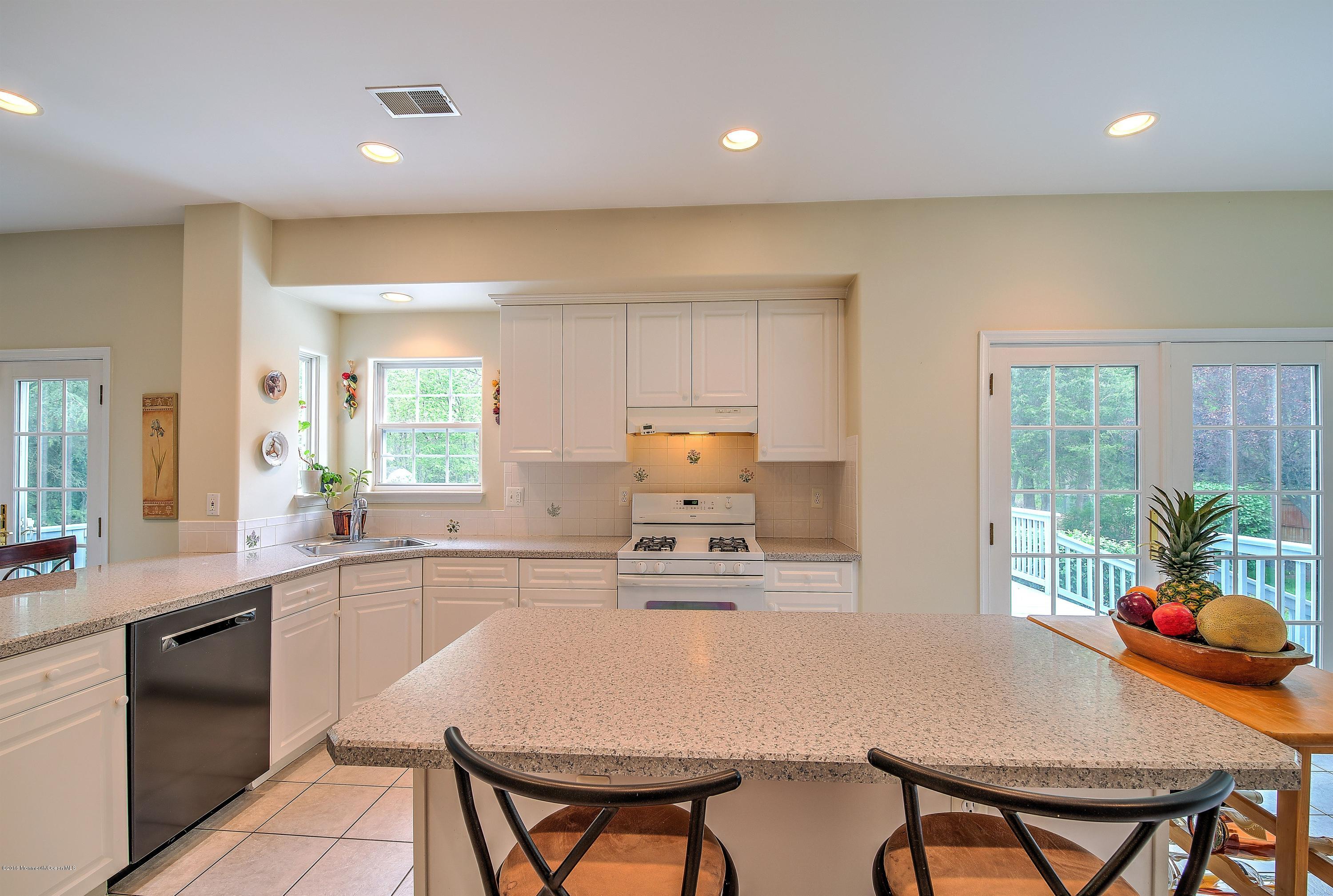 362 Jackson Mills Road Jackson, NJ 08527 - Photo 6 of 34 a kitchen with a table chairs refrigerator and cabinets