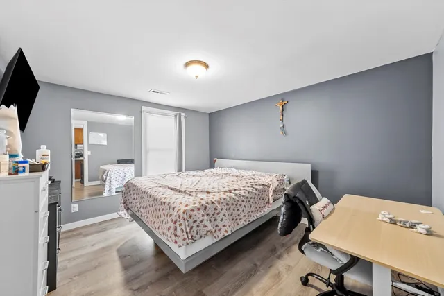 a bedroom with a bed and a flat screen tv