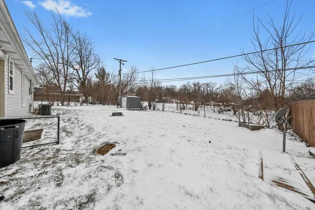 a view of a yard covered in snow