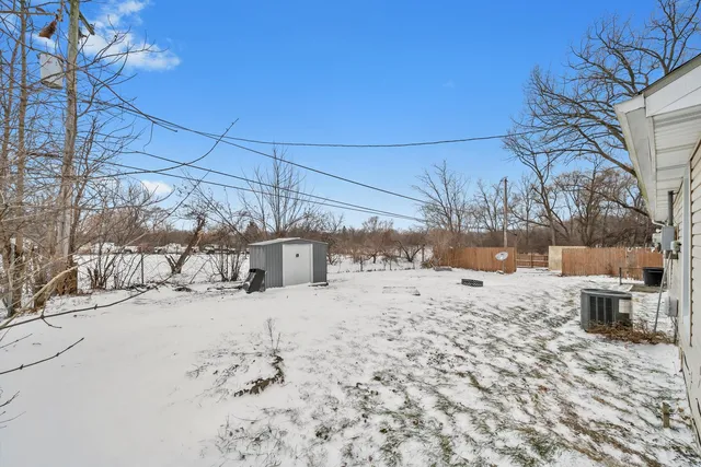 a view of a yard covered in snow