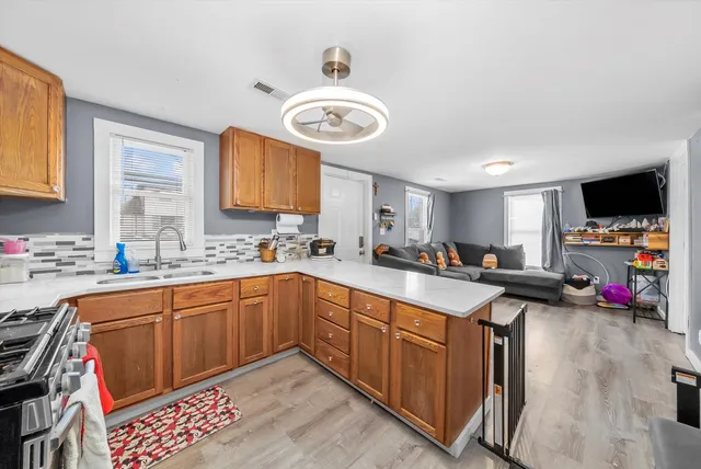 a kitchen with stainless steel appliances granite countertop a sink and cabinets