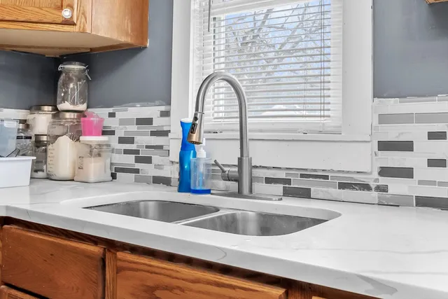 a kitchen with a sink cabinets and a wooden floor