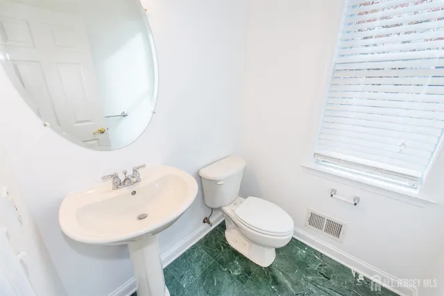 a view of empty room with a fireplace and window