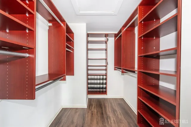 a spacious bathroom with a double vanity sink mirror and bathtub