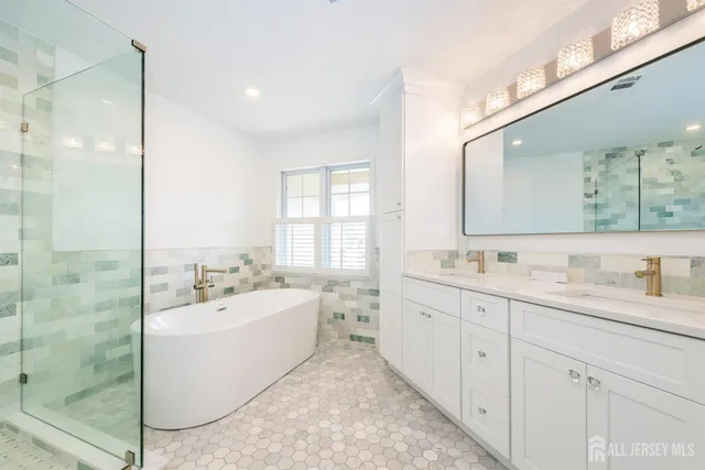a white bath tub sitting next to a shower
