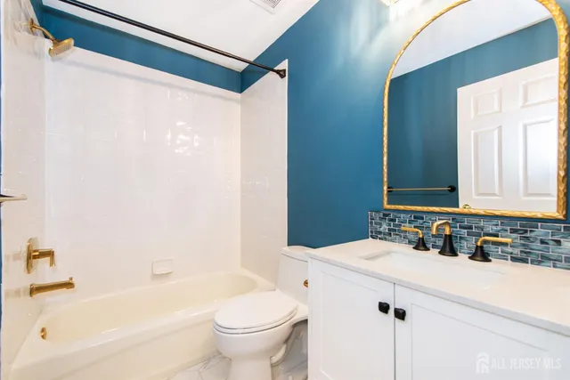 a view of a house with a wooden fence