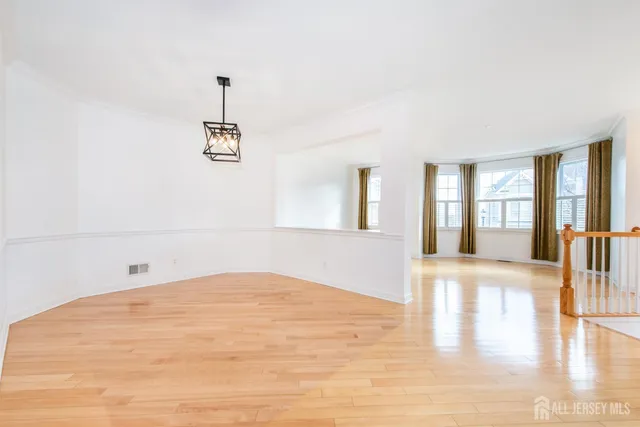a view of empty room with wooden floor and fireplace