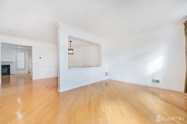 a kitchen with stainless steel appliances a stove top oven a sink dishwasher and a fireplace with wooden floor