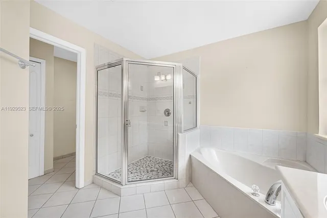 a view of a brick house with large windows and plants