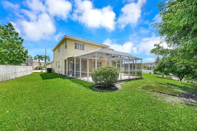 a view of a house with a backyard