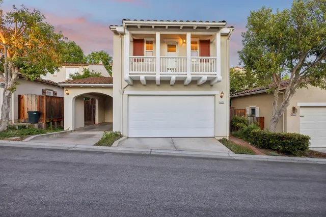 a front view of a house with a yard and a garage