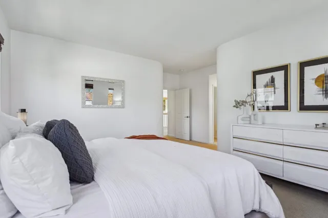 a bedroom with a bed and a potted plant