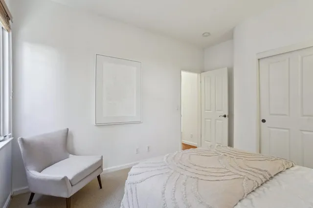 a bedroom with a bed and lamp