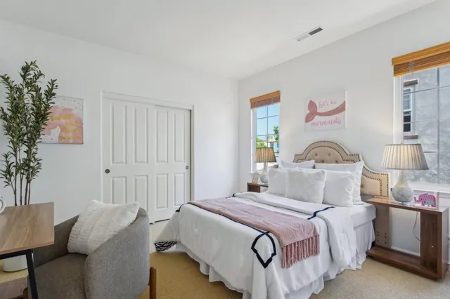 a bedroom with a bed and a painting on the wall