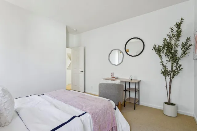 a white bath tub sitting next to a shower