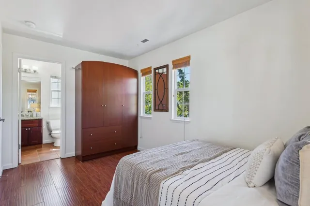 a front view of a house with a lots of flowers