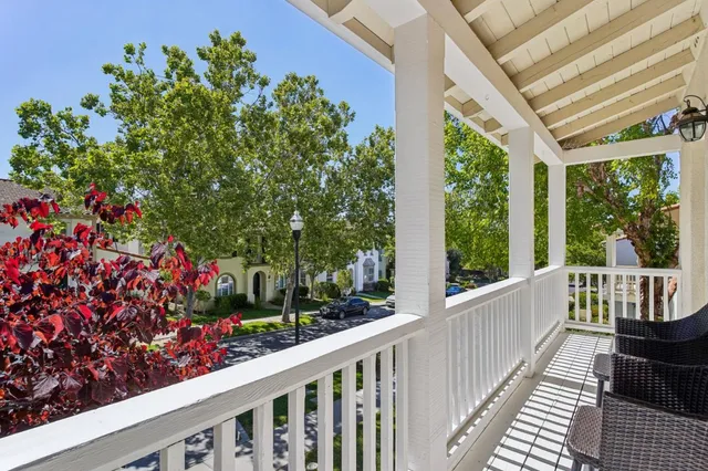 a view of a patio with table and chairs and wooden fence