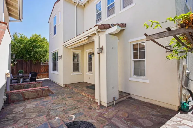 a front view of a house with a garden and plants