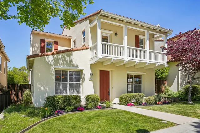 a backyard of a house with potted plants
