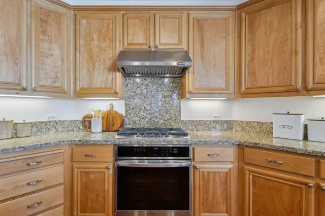a dining room with furniture a potted plant and wooden floor