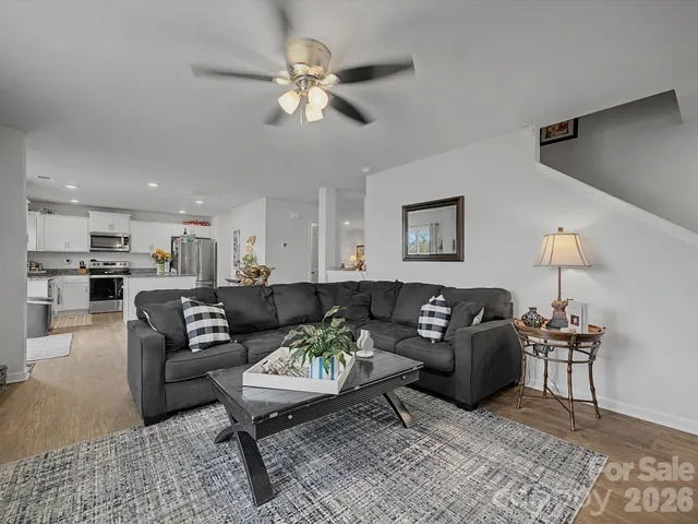 a living room with furniture a view of bedroom and a couch
