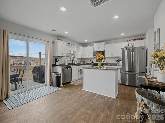 a kitchen with stainless steel appliances a refrigerator sink and cabinets