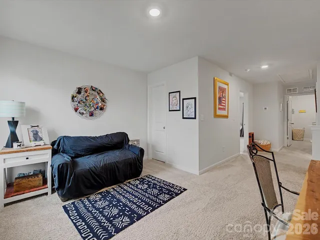 a bedroom with furniture and a rug