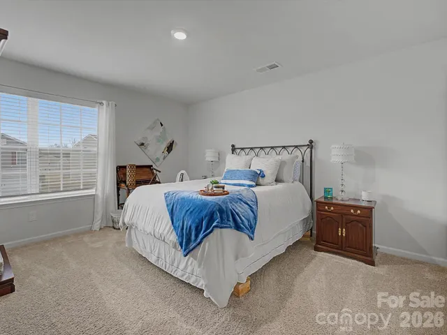 a bedroom with a bed and window