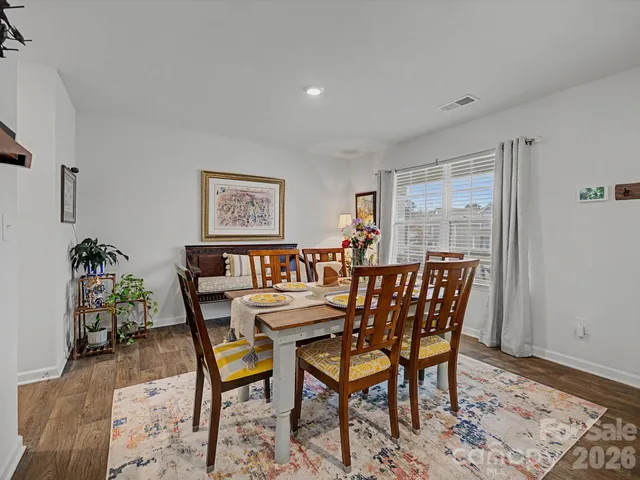 a dining room with furniture and wooden floor
