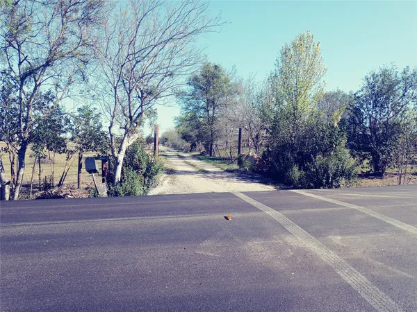 a view of a house with a yard and basketball court