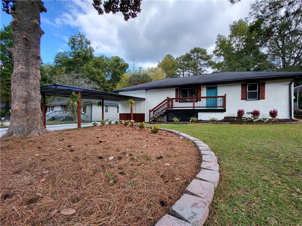 1724 Derrill Drive Decatur, GA 30032 - Photo 1 of 1 a front view of a house with a garden and trees