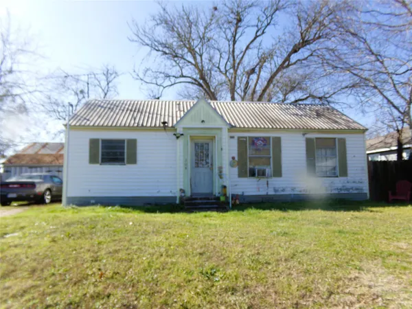 a view of a house with a yard and pathway