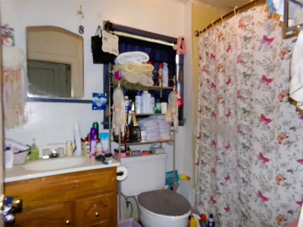 a bathroom with a sink toilet and mirror