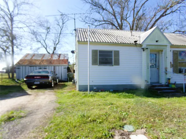 a view of a house with a yard and sitting area