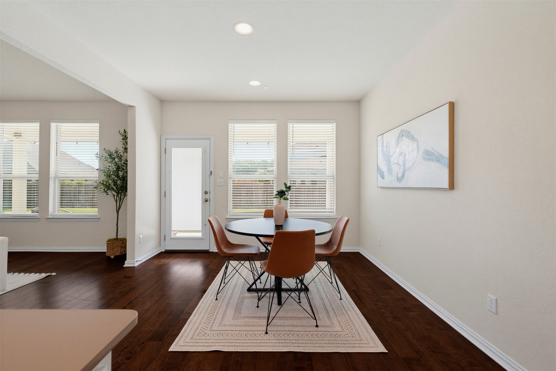 12613 Twisted Root Drive Manchaca, TX 78652 - Photo 28 of 33 Rich hardwood floors complement an inviting dining area, perfect for daily meals or intimate gatherings.
