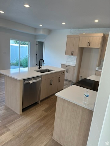 1886 North 300 West Logan, UT 84341 - Photo 5 of 18 Modern kitchen featuring wood-finish cabinetry, light-toned countertops, and a built-in stainless steel dishwasher