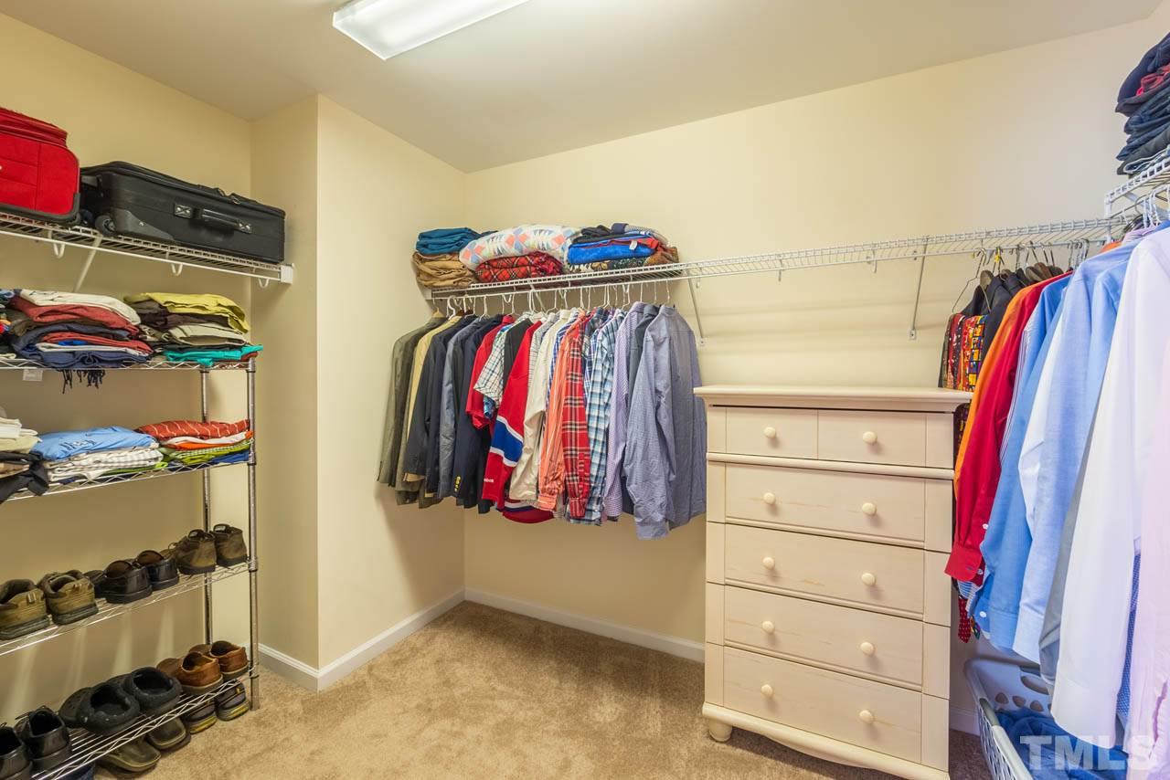 227 Strolling Way Durham, NC 27707 - Photo 17 of 25 a view of walk in closet with clothes and shoes