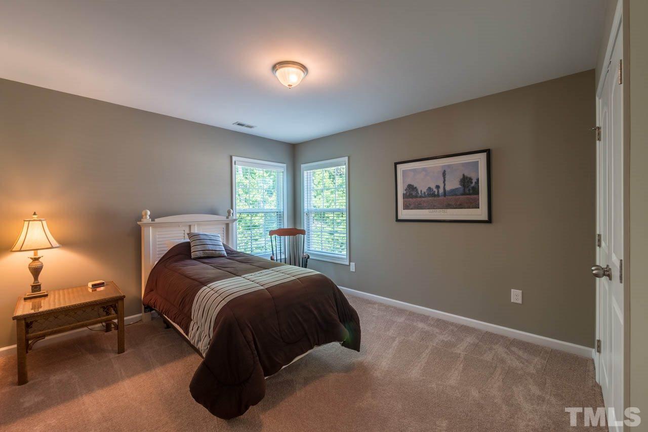 227 Strolling Way Durham, NC 27707 - Photo 18 of 25 a bedroom with a bed and a night stand