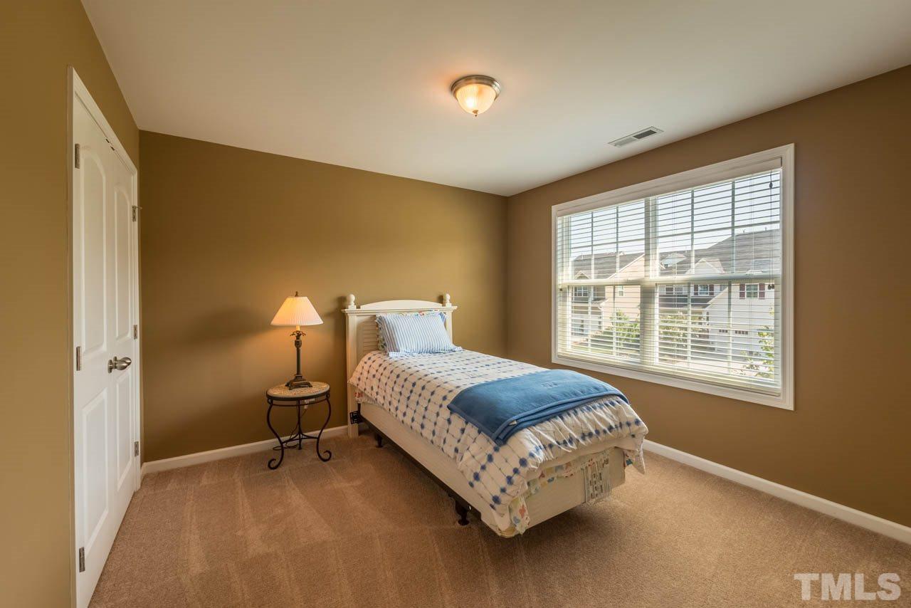 227 Strolling Way Durham, NC 27707 - Photo 20 of 25 a bedroom with a bed and a window